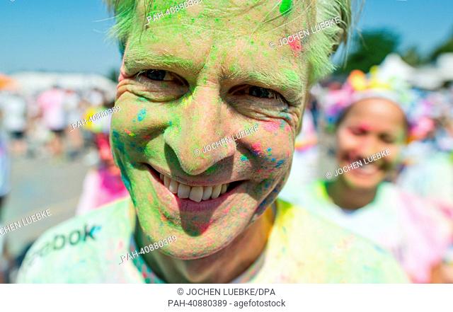 A participant in the Color Run smiles after the race in Hanover, Germany, 07 July 2013. Several thousand participants took part in a 5 km run during which tehy...