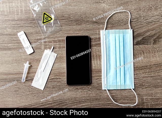 coronavirus self testing kit, smartphone and mask