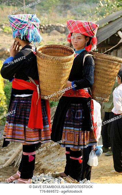 Big Haired Hmong girls and their baskets in the market in Tam Duong Vietnam