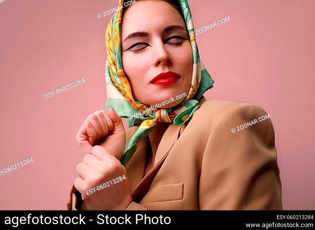 Portrait of stylish and fashion young woman, wearing head scarf. High quality photo