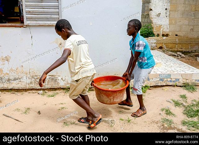 Boys fetching water in Thiaoune, Senegal, West Africa, Africa