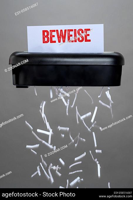 A shredder destroying a document - Evidence - Beweise German