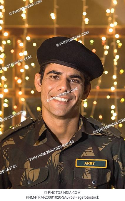 Army soldier smiling in front of Diwali decoration