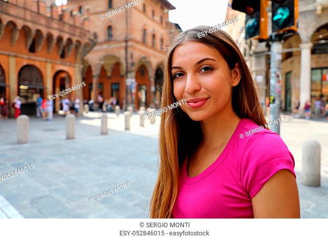 Portrait of beautiful smiling girl posing outdoor with city on background. Copy space