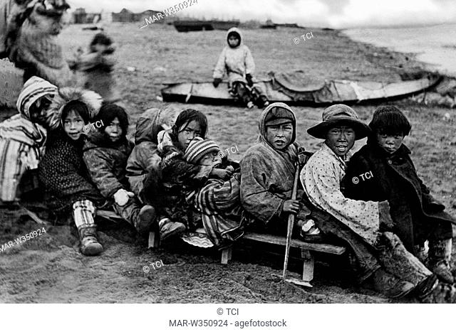 america, alaska, Eskimo children play with slide on the sand, 1910-20