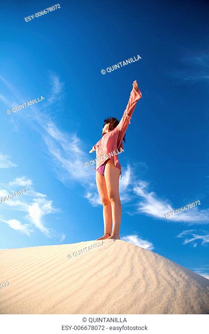 woman at sand dune in spain with african horizon