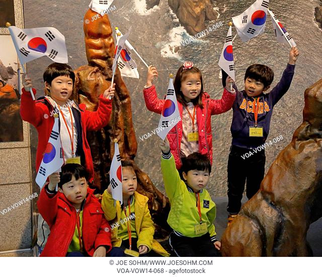 Students wave Korean flags at War Memorial of Korea, Jeonjaeng ginyeomgwan, Yongsan-dong, Seoul, South Korea - NOVEMBER 2013