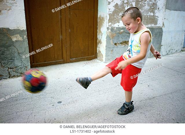 boy playing football on a village, Ludiente, Castellón, Spain