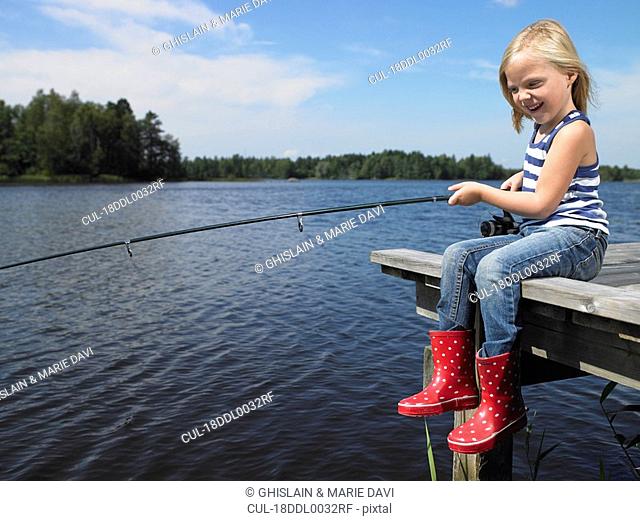 Girl fishing from a dock
