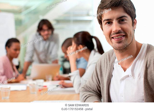 Portrait of smiling businessman in meeting