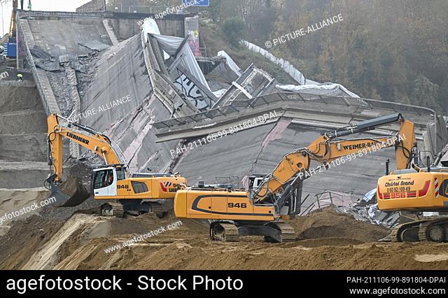 06 November 2021, Hessen, Wiesbaden: Excavators are in action after the dilapidated Salzbachtal bridge on Autobahn 66 in Wiesbaden was blown up