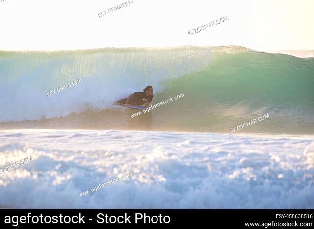 EL Cotillo, Spain - Dec 22, 2015: Body Surfer riding a powerful wave at El Cotillo beach, famous surfing destination on Fuerteventura, Canary Islands