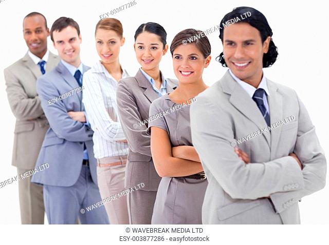 Big close-up of a business team in a single line looking towards the left side with focus on the first woman