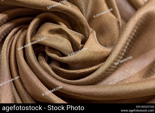 Shiny cloth background with beige vial textile