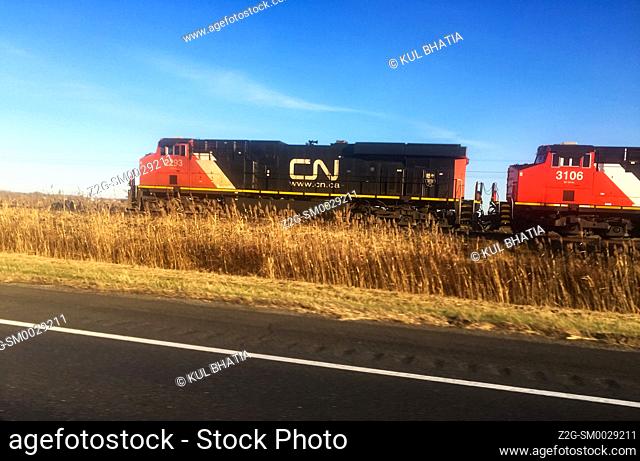 A passenger train going parallel to the road, Quebec, Canada