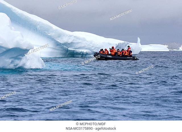 Passengers exploring icebergs near Pleneau Island Antarctica