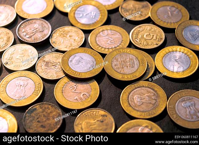 Heap of Gold Colored Indian Rupee Coin currency on rustic floor. Full Frame. High Angle View. Business Finance and financial Investment Background