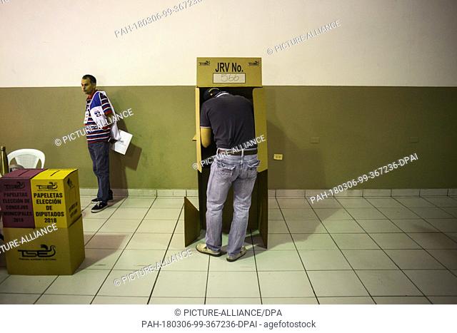 04 March 2018, El Salvador, San Salvador: A man votes for the parliamentary and municipal elections at the Lehen School. According to the highest electoral...