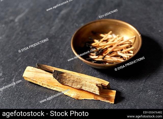 palo santo sticks and cup with burnt matches