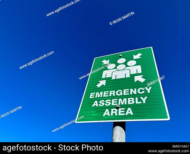Emergency assembly are sign against blue sky
