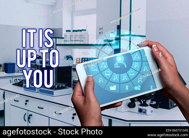 Conceptual caption It Is Up To You, Business showcase Used to tell a person that they are the one to decide Hands Holding A Mobile Phone In Laboratory Showing...