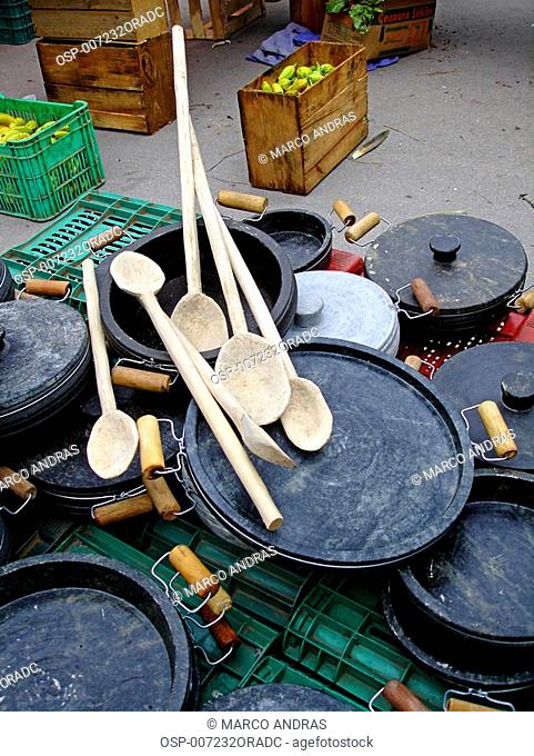 a sale of wooded spoons and pots and pans of clay