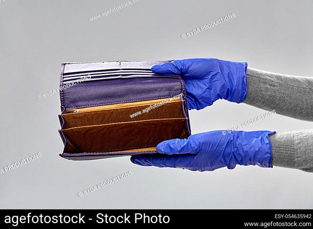 close up of hands in gloves with empty wallet