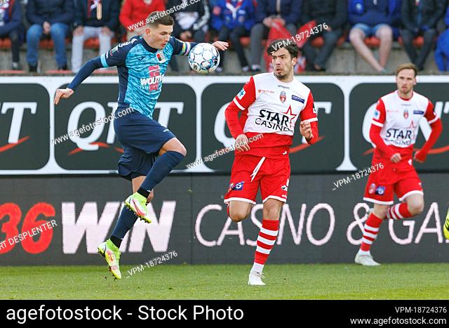 Rwdm's William Togui and Mouscron's Marko Babic fight for the ball during a soccer match between RE Mouscron and RWDM Molenbeek