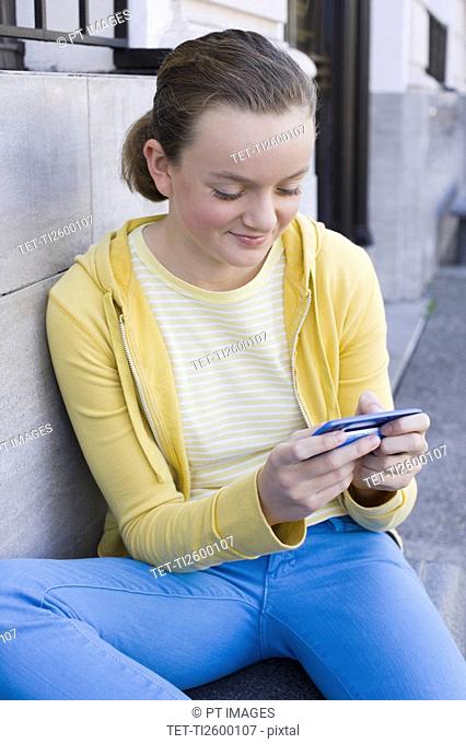 Girl text messaging on steps