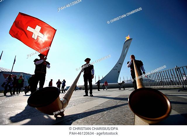 Swiss alphorn players from Engadin pose in front of the Olympic Flame in the Olympic Park at the Sochi 2014 Olympic Games, Sochi, Russia, 08 February 2014