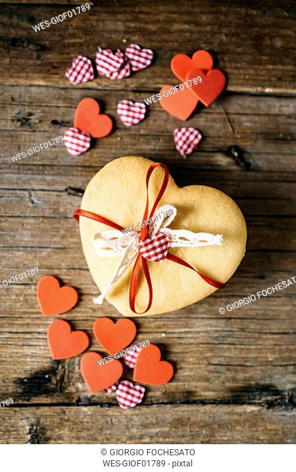 Stack of heart-shaped shortbreads tied with lace and ribbon on wood