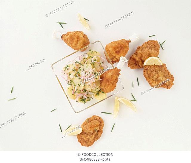 Fried chicken pieces with potato salad