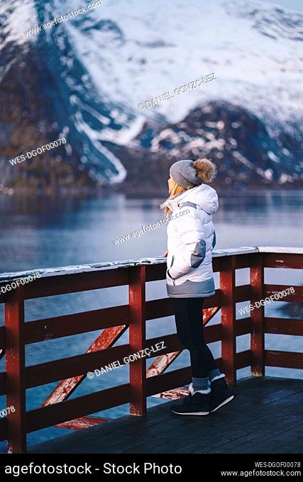Tourist enjoying the view at Hamnoy, Lofoten, Norway
