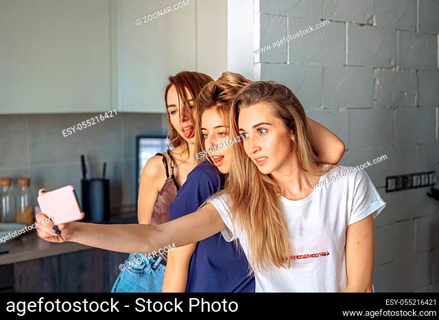 girls take selfy on the phone in the apartment
