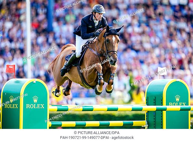 21 July 2019, North Rhine-Westphalia, Aachen: Equestrian sports, CHIO, jumping: Show jumper Ben Maher from Great Britain on his horse Explosion jumps over an...