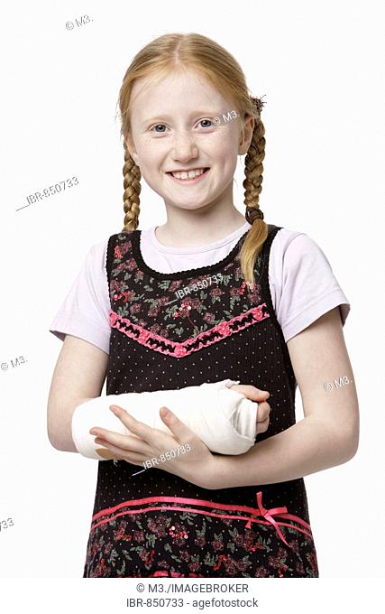 8-year-old girl with her arm in plaster, laughing