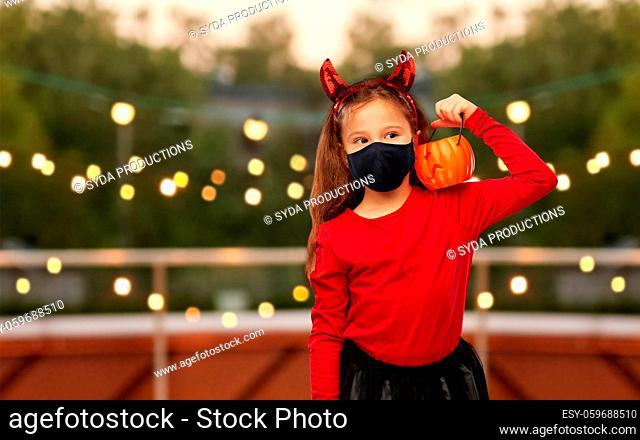 girl in halloween costume and mask