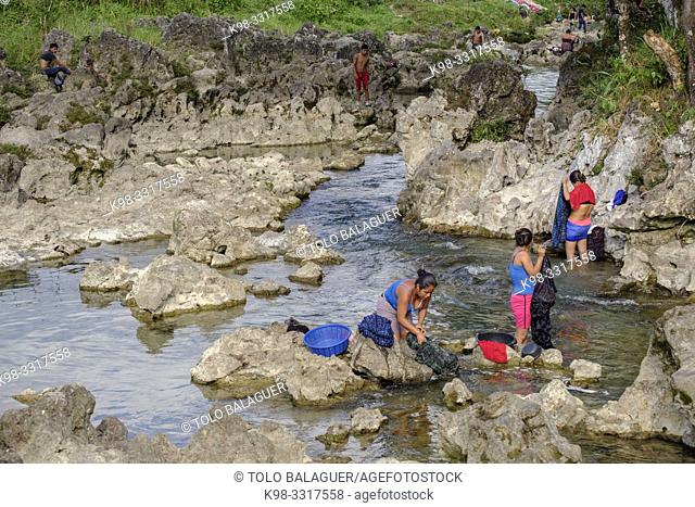 women washing clothes in the river Cuatro Chorros, La Parroquia, Zona Reina, Quiche, Guatemala, America Central