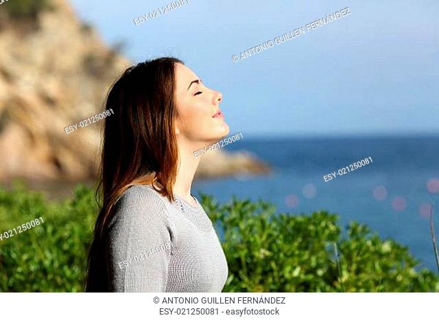 Woman breathing fresh air relaxed on vacation