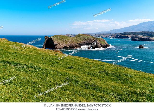 Scenic view of sea against blue sky in rocky coast. Borizo Beach, Llanes, Asturias, Spain