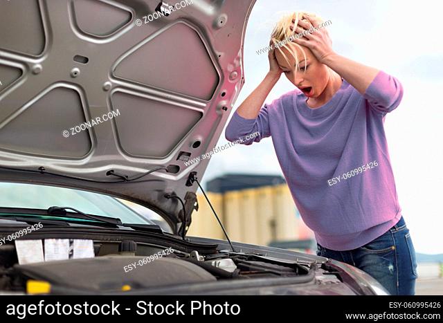 Stressed Young Woman with Engine Breakdown Car Defect