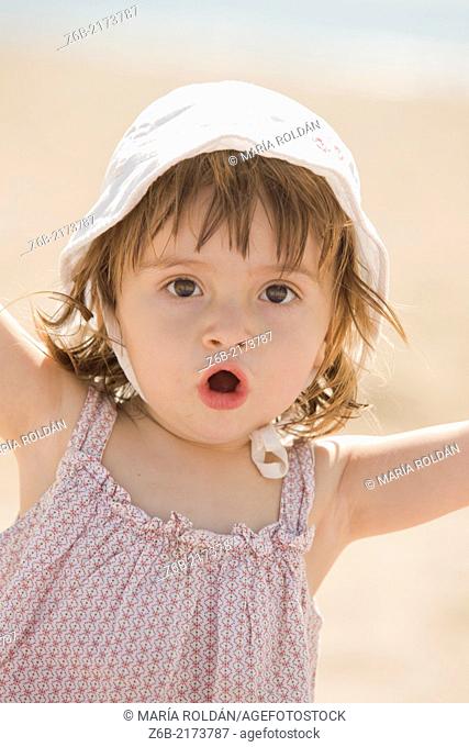 Baby girl, 18/19 months, Outdoors, Sunny, Beach, Mediterranean sea, Valencia, Spain, vacation, Hat