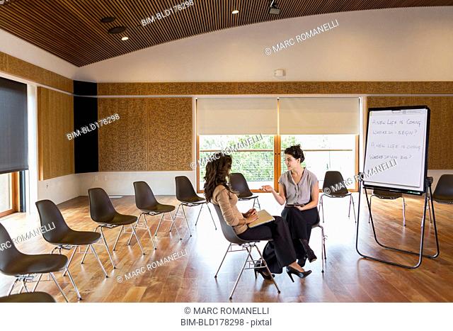 Businesswomen talking in meeting room