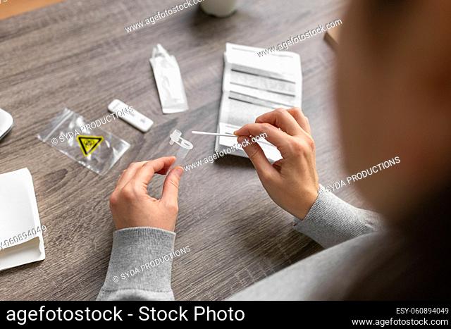 woman making self testing coronavirus test at home