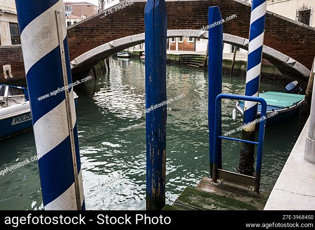Venetian Paline de Casada (Venetian poles with stripes/mooring posts). The canals of Venice. Venice, Veneto Region, Italy, Europe