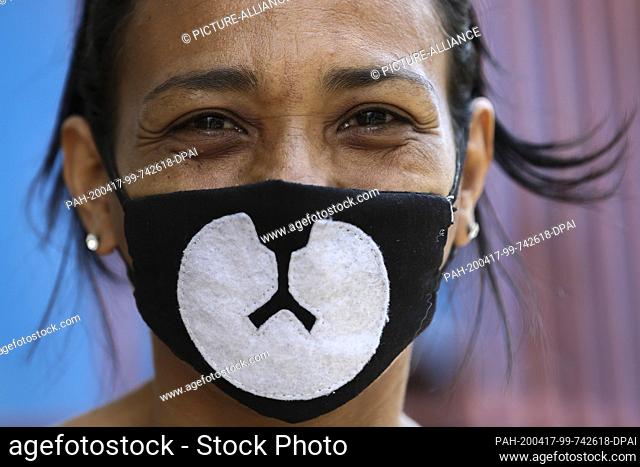 15 April 2020, Venezuela, Caracas: A woman is wearing a face mask with a ""bear's mouth"" on it in the middle of the Corona pandemic