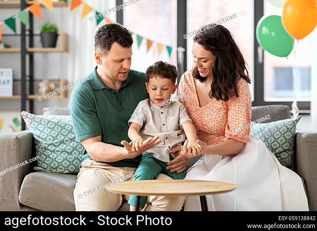 happy family with little son at birthday party