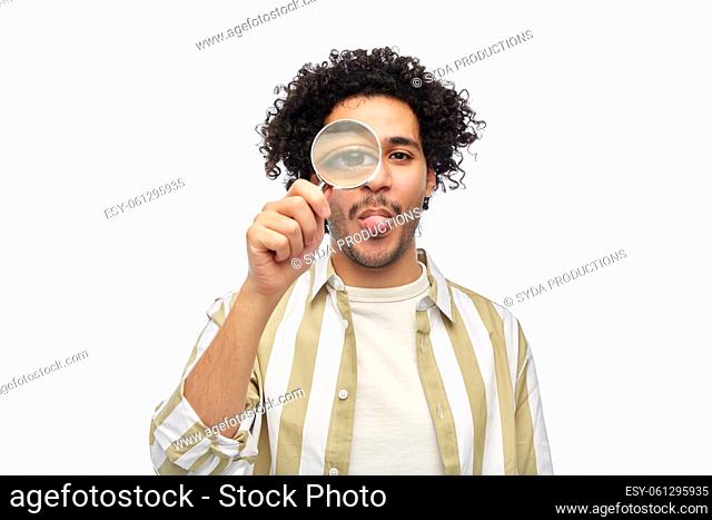 happy man looking through magnifying glass
