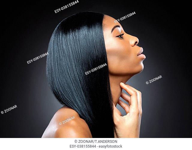 Profile of a black beauty with perfect straight and shiny hair