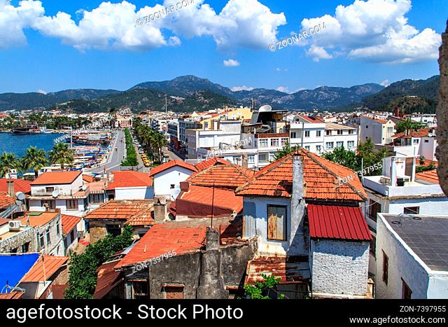 MUGLA, TURKEY - JUNE 1, 2015 : Top view of Marmaris town, roofs of the old houses, on cloudy sky background